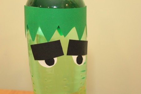 Halloween Frankenstein Soda Bottle Craft - tape eyes to bottle just below the hairline