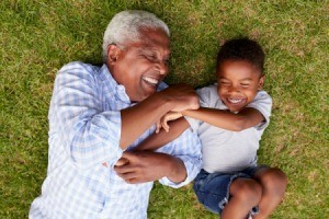 Happy Grandfather and Grandson in Grass