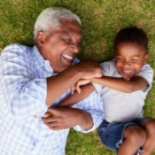 Happy Grandfather and Grandson in Grass