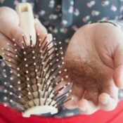 Hair in Hands and on Hairbrush