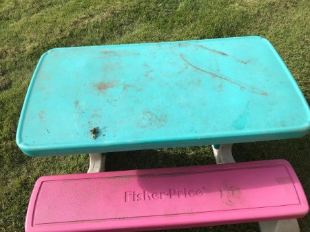A colorful plastic table for children, found on the curb.