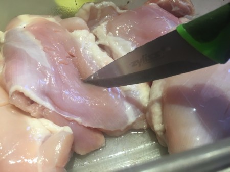 poking chicken breasts with knife