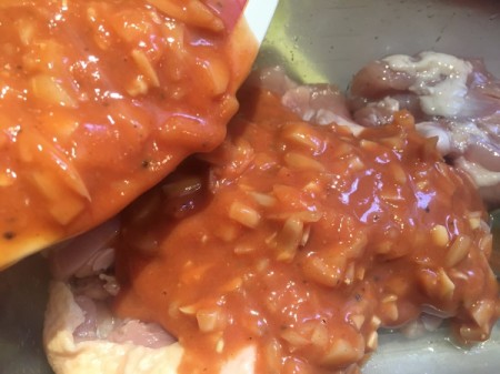 adding marinade to chicken