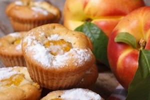 Peach muffins sprinkled with powdered sugar.