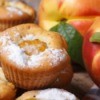 Peach muffins sprinkled with powdered sugar.