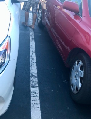 Two cars parked in a parking lot.