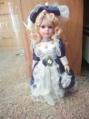 Identifying a Porcelain Doll - doll wearing a blue and white outfit