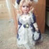 Identifying a Porcelain Doll - doll wearing a blue and white outfit