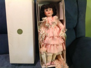 Value of Heritage House Musical Doll - doll wearing pink ruffle dress in a box