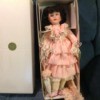 Value of Heritage House Musical Doll - doll wearing pink ruffle dress in a box