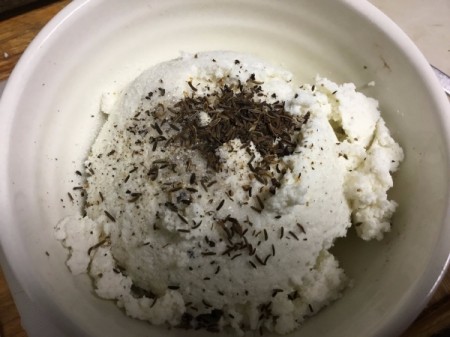 adding spices to cheese curds