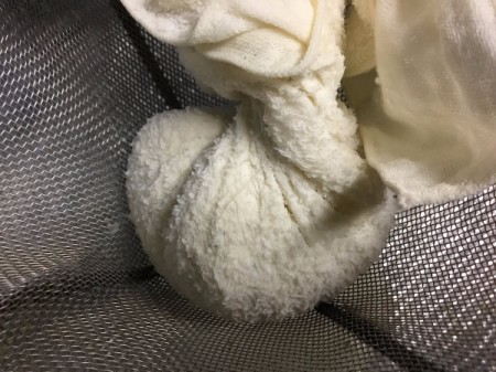 squeezing cheese in cheesecloth