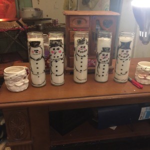 Waving Snowman Candles - several snowman candles  on table top