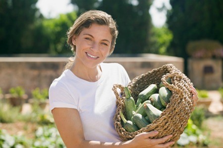 Woman With Summer Squash Harvest
