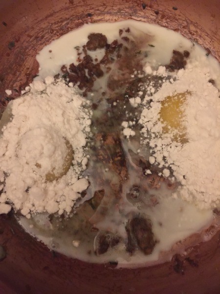 adding flour to eggs in skillet