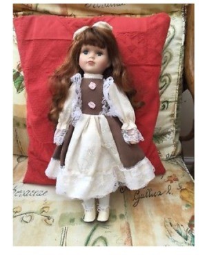 Identifying a Doll and Finding Its Value - auburn haired doll wearing a white and mauve dress and lace up shoes