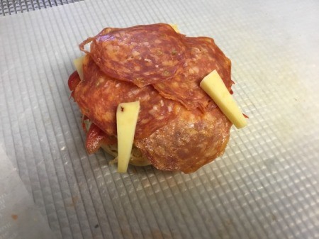 adding salami and cheese fangs