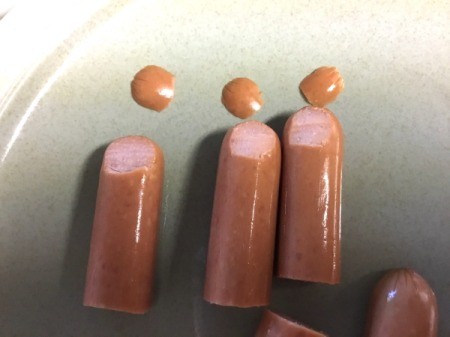 cutting tips of hotdogs