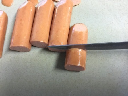 cutting hotdogs