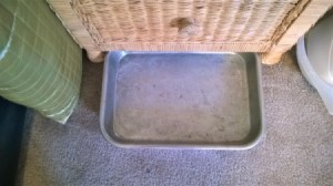A baking tray next to a nightstand.