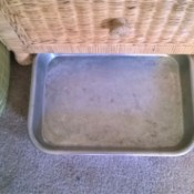 A baking tray next to a nightstand.