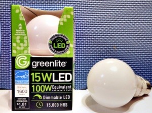 A 15w LED lightbulb in a package with a loose one next to it.