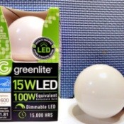 A 15w LED lightbulb in a package with a loose one next to it.
