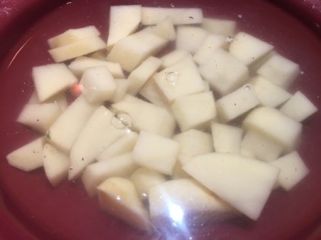 diced potatoes in bowl with water