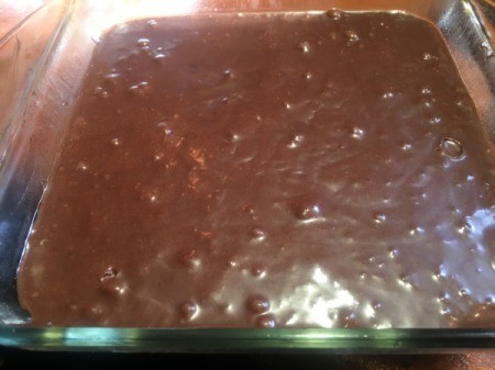 chocolate cake batter in glass baking dish