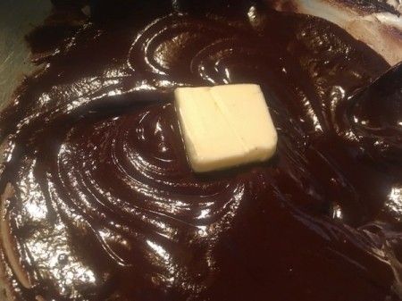 adding butter to frosting