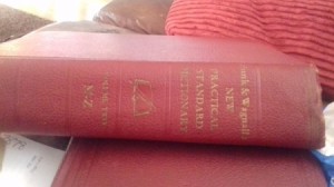 A Funk and Wagnalls dictionary with a red cover.