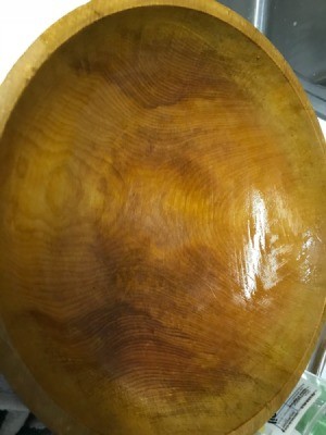 A wooden serving bowl that has been oiled with mineral oil to preserve it.