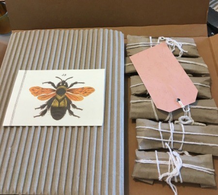 Gifts wrapped in corrugated cardboard with white string.