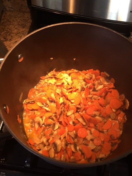 adding carrots to garlic and carrots
