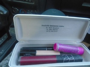 An eyeglass case filled with makeup.