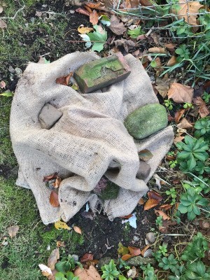 Burlap placed over a bush to protect it during winter.