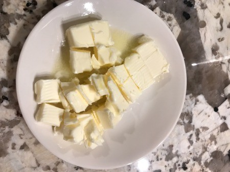 butter cut in pieces in bowl