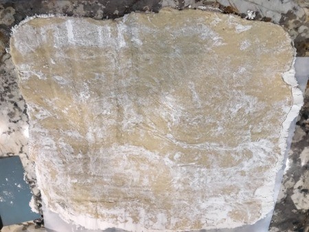 flattened dough on marble glad