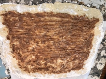 flattened dough with filling spread
