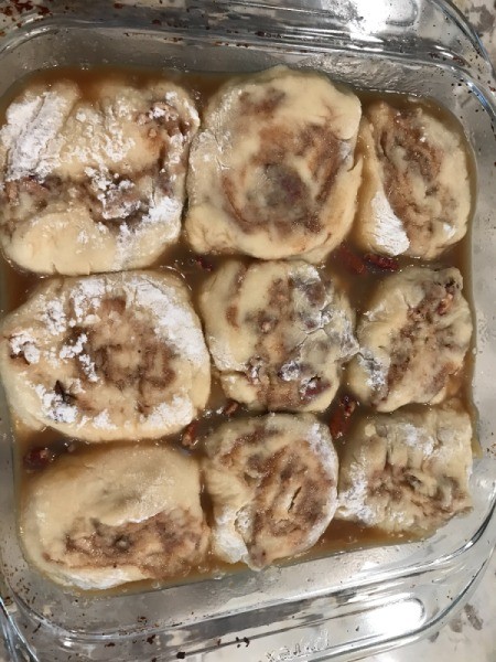 cut roll buns in baking pan with egg wash