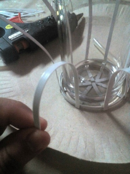 Decorative Recycled Drinking Glass Stand - place the glass inside the circle and bend each fastener down