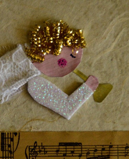 Angel Blowing On Trumpet Christmas Card - add cut pieces from the scrubber as hair and pens to make eye and pink cheek