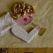 Angel Blowing On Trumpet Christmas Card - add cut pieces from the scrubber as hair and pens to make eye and pink cheek