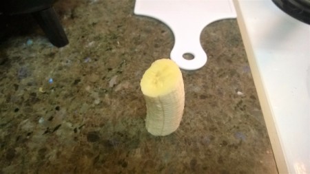 A piece of peeled banana, ready for cutting.