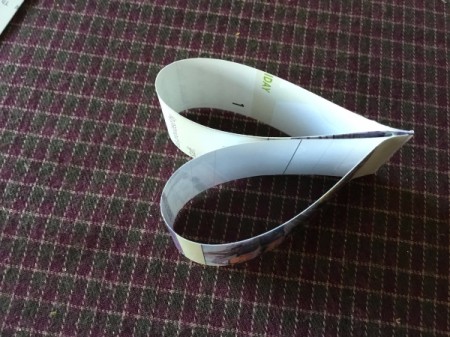 Upcycled Calendar Christmas Wreath - pinch and hold until the glue sets