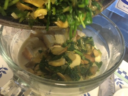 adding sautéed vegetables to egg, milk and bread