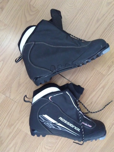 A pair of cross country ski boots in need of cleaning.