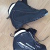 A pair of cross country ski boots in need of cleaning.
