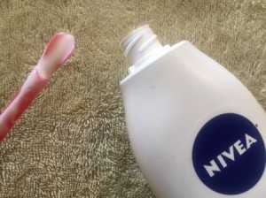 A Slurpee straw being used to remove lotion from a bottle.