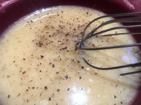 mixing egg and chicken broth